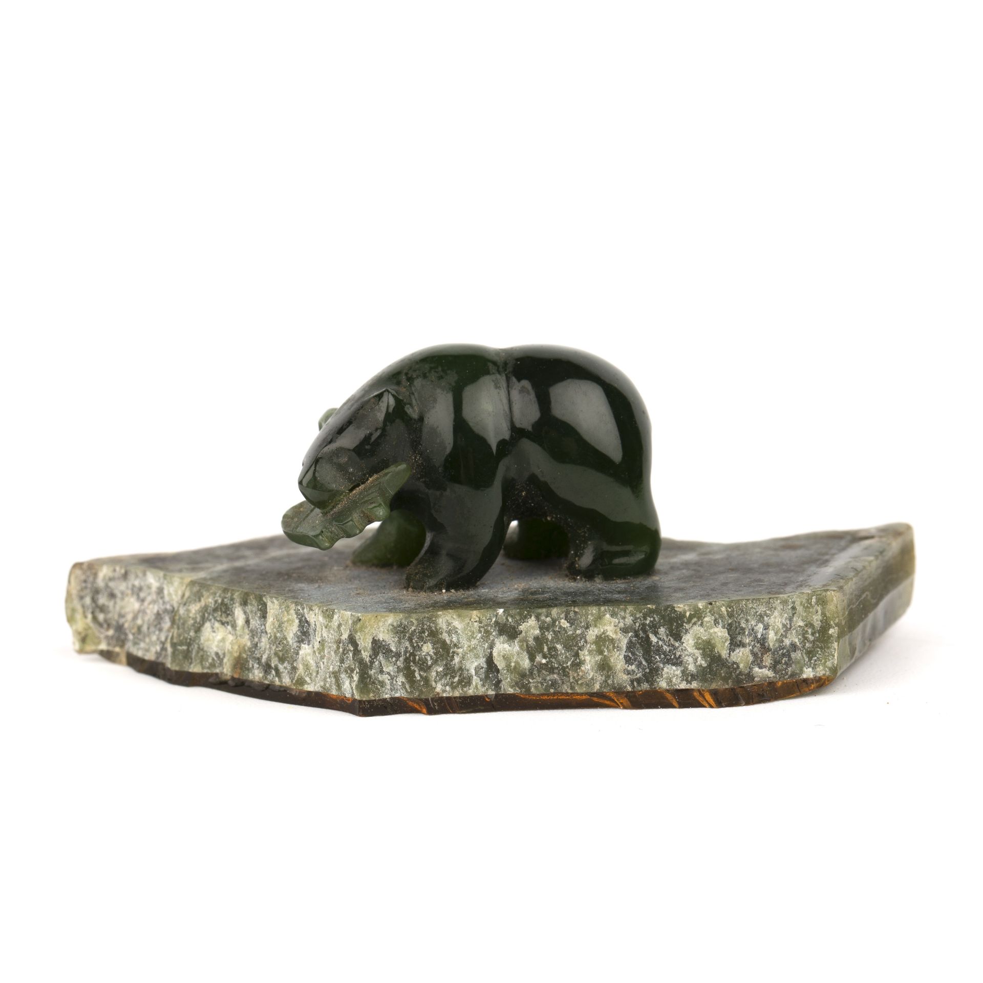 A small Canadian jade carving of a bear and salmon, overall 6cm wide 2.5cm high