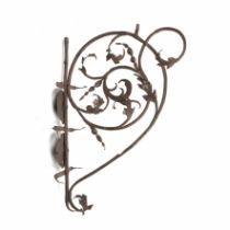 An early 18th century wrought iron bracket with two candle sconces and foliate designs 60cm x 45cm