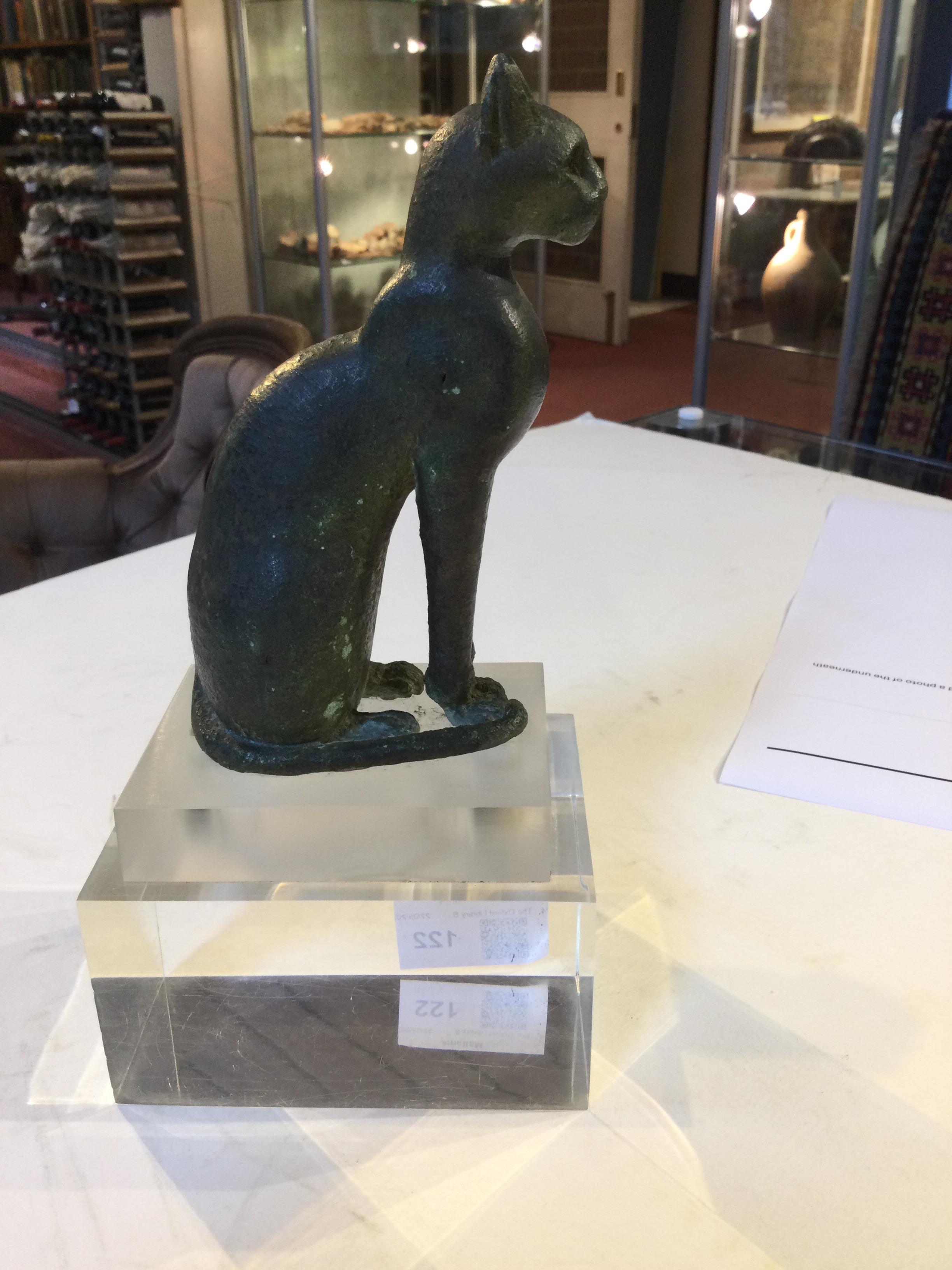 An Egyptian bronze cat figure , hollow cast, depicted seated and alert with forepaws together and - Image 10 of 26