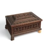 A 19th century Indian carved sandalwood box the lid opening to reveal nine compartments 39cm wide