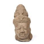 An Indian carved stone head 14cm wide 29cm high