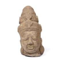 An Indian carved stone head 14cm wide 29cm high