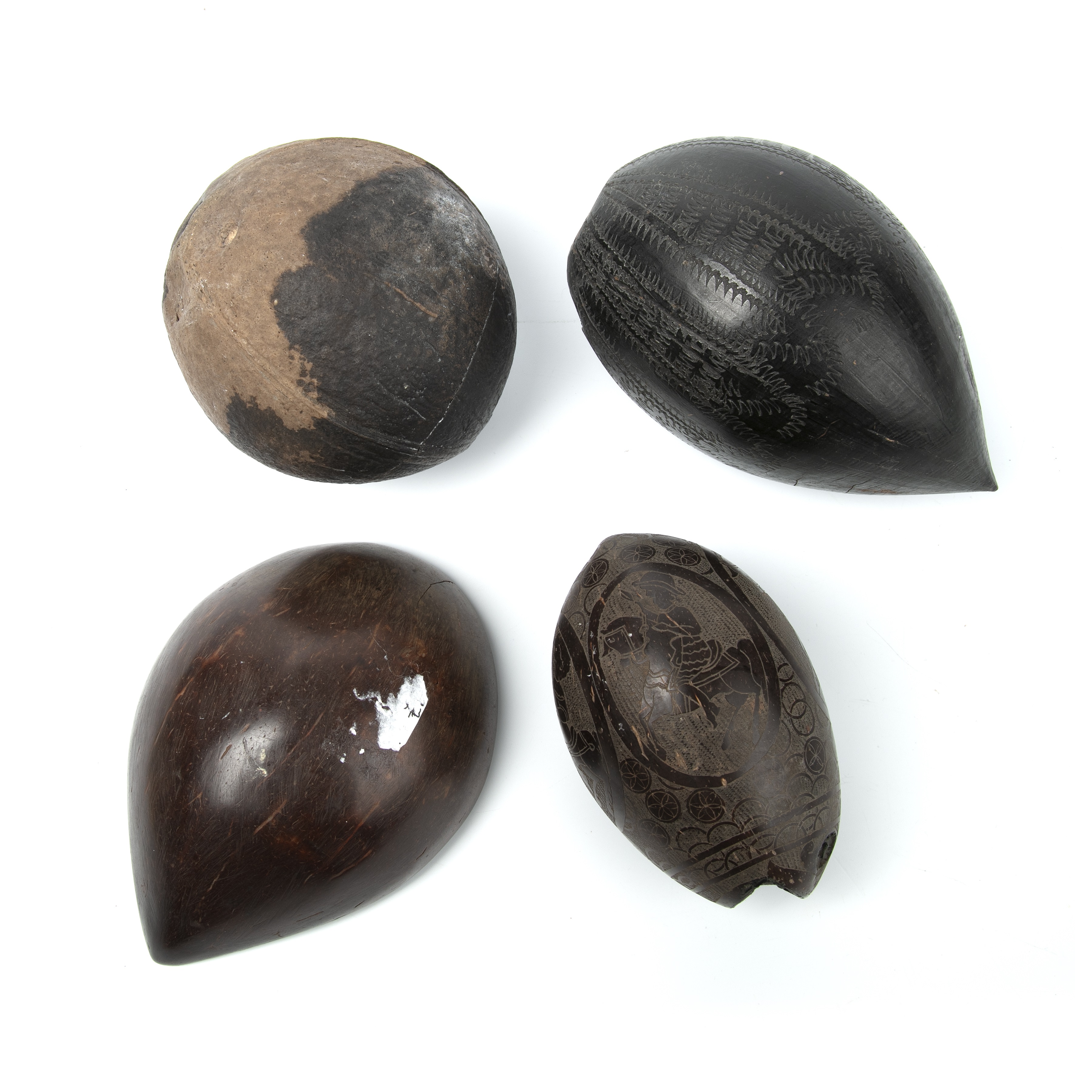 Four antique tribal nuts, two with engraved decoration, the largest 14cm high - Image 2 of 2