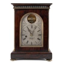 A mid 19th century rosewood campaign travelling timepiece with a visible escapement and a fusee