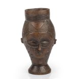 A west African Kuba carved hardwood wine cup 10.5cm wide 19cm high