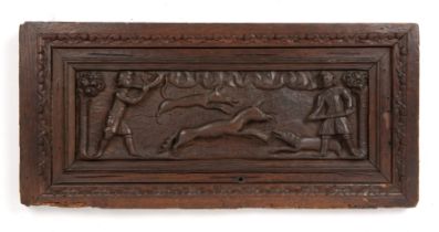 An antique possibly Flemish carved oak hunting scene mounted in carved oak frame overall 28cm x 61cm