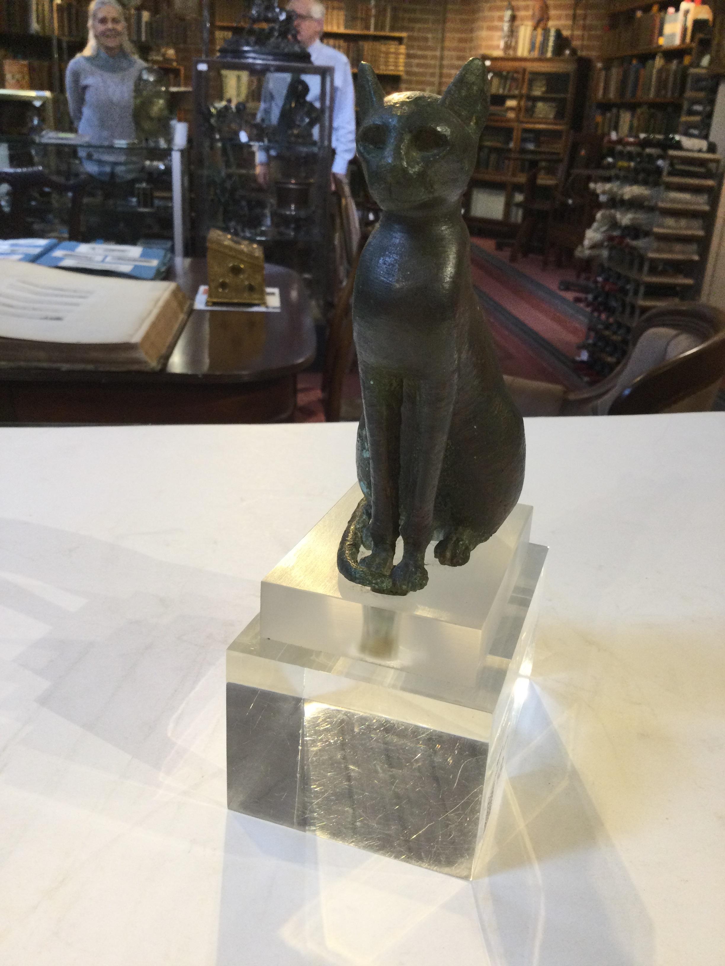 An Egyptian bronze cat figure , hollow cast, depicted seated and alert with forepaws together and - Image 6 of 26