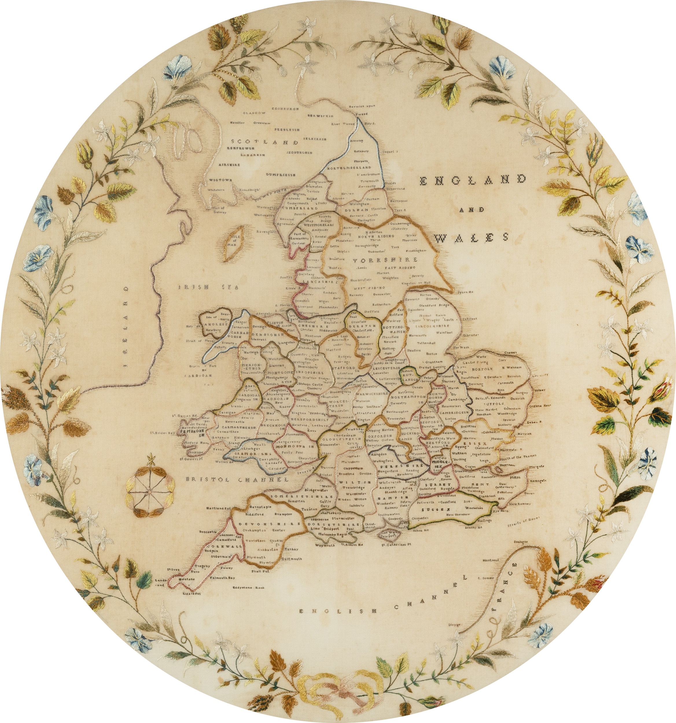 A 19th century embroidered map of England and Wales with a floral border 54cm diameter. mounted in a - Image 2 of 3