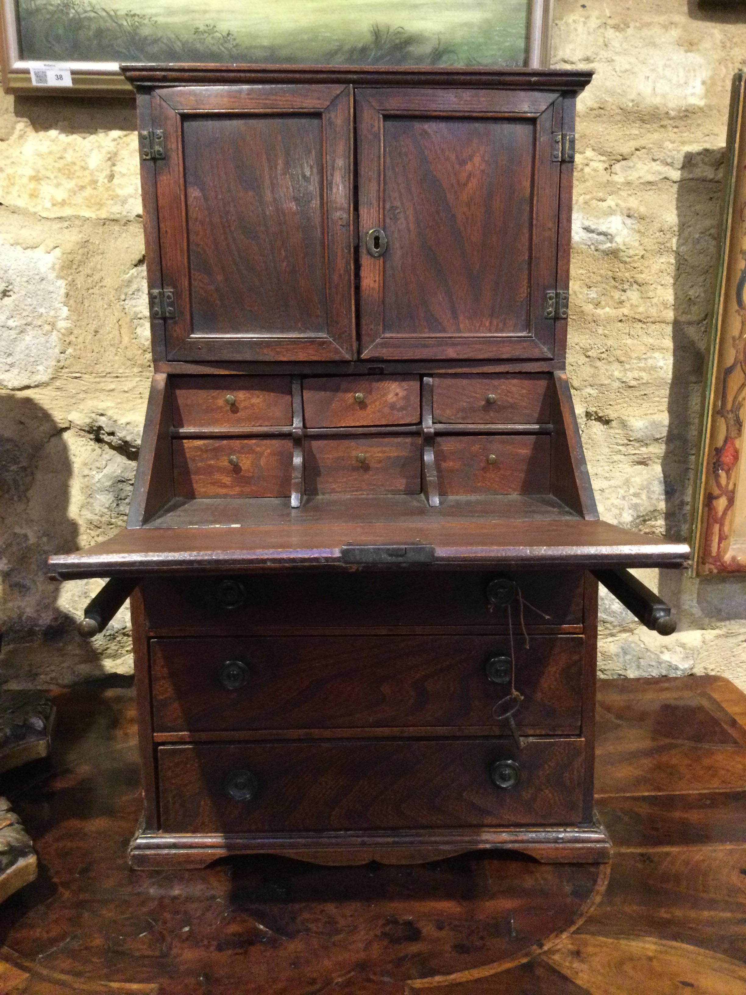 An 18th century elm apprentice bureau bookcase with panelled doors above a fall front three - Image 21 of 26