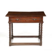 An English 17th century tropical hardwood side table with a single drawer and turned supports united