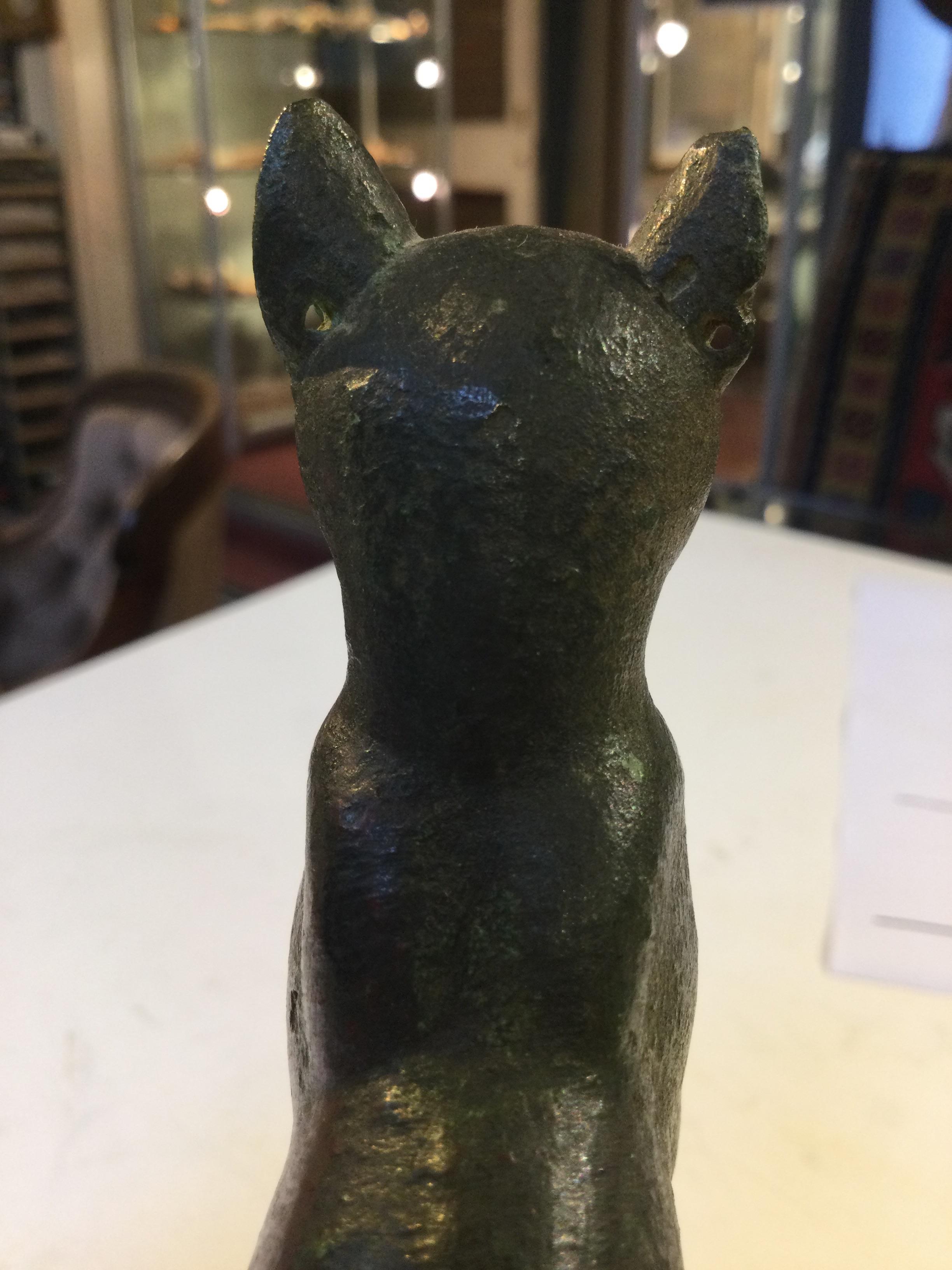 An Egyptian bronze cat figure , hollow cast, depicted seated and alert with forepaws together and - Image 12 of 26