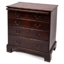 A George III mahogany chest of four long drawers having brass swan neck handles, a brushing slide