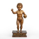 A 17th/18th century Italian gilded and carved limewood cherub on a rectangular gilded base 24cm wide