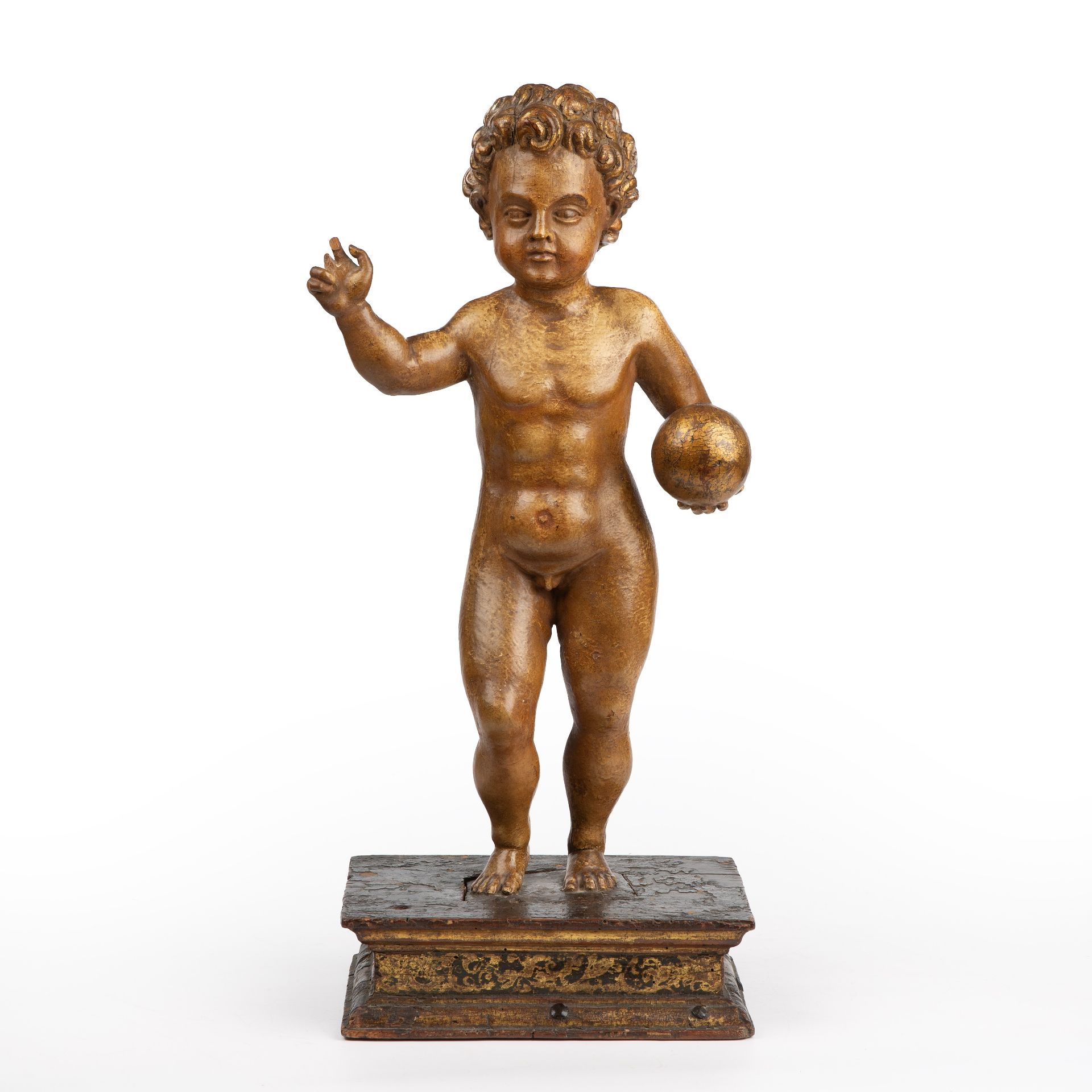 A 17th/18th century Italian gilded and carved limewood cherub on a rectangular gilded base 24cm wide