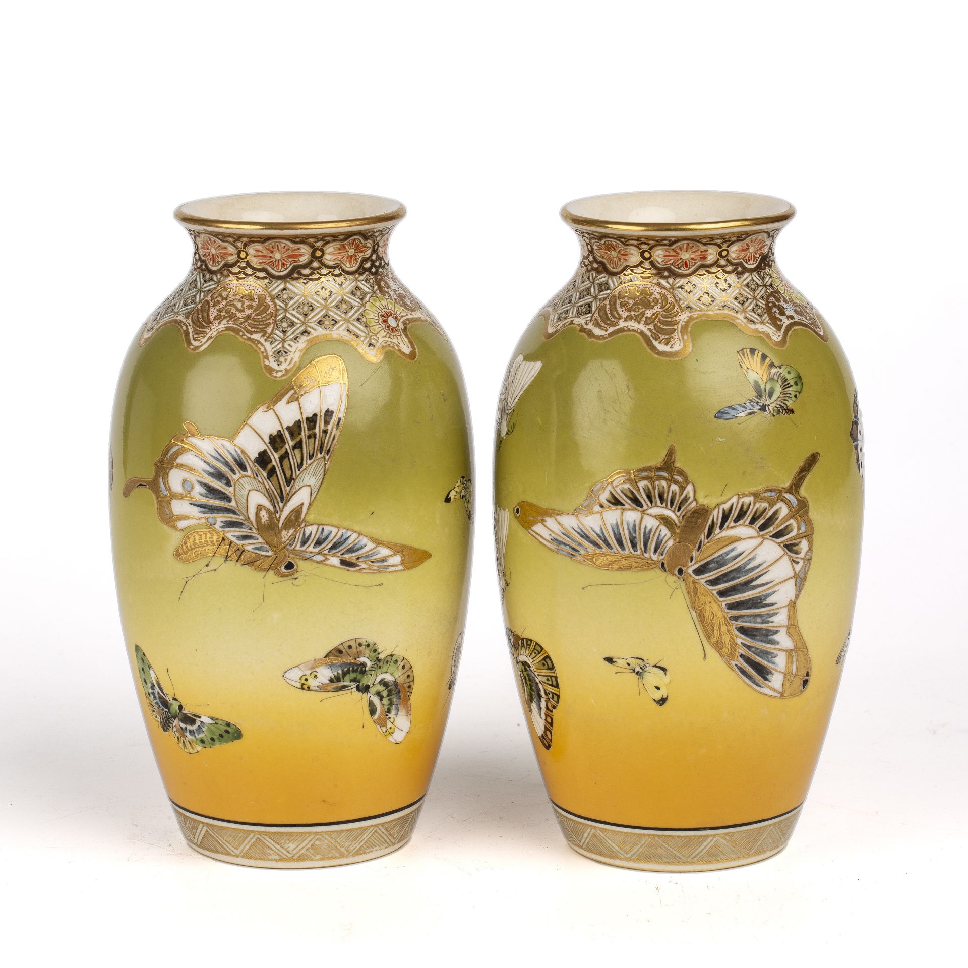 A pair of Japanese Meiji Satsuma porcelain vases decorated with butterflies and moths, with