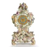 A 19th century porcelain mantel timepiece, the engine turned gilt dial with blue enamel Roman