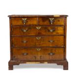 An 18th century walnut chest of two short and three long drawers, raised on bracket feet 96cm wide