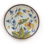 An 18th century Dutch Delft charger, decorated with a bird, circa 1740, 32cm diameter Good with