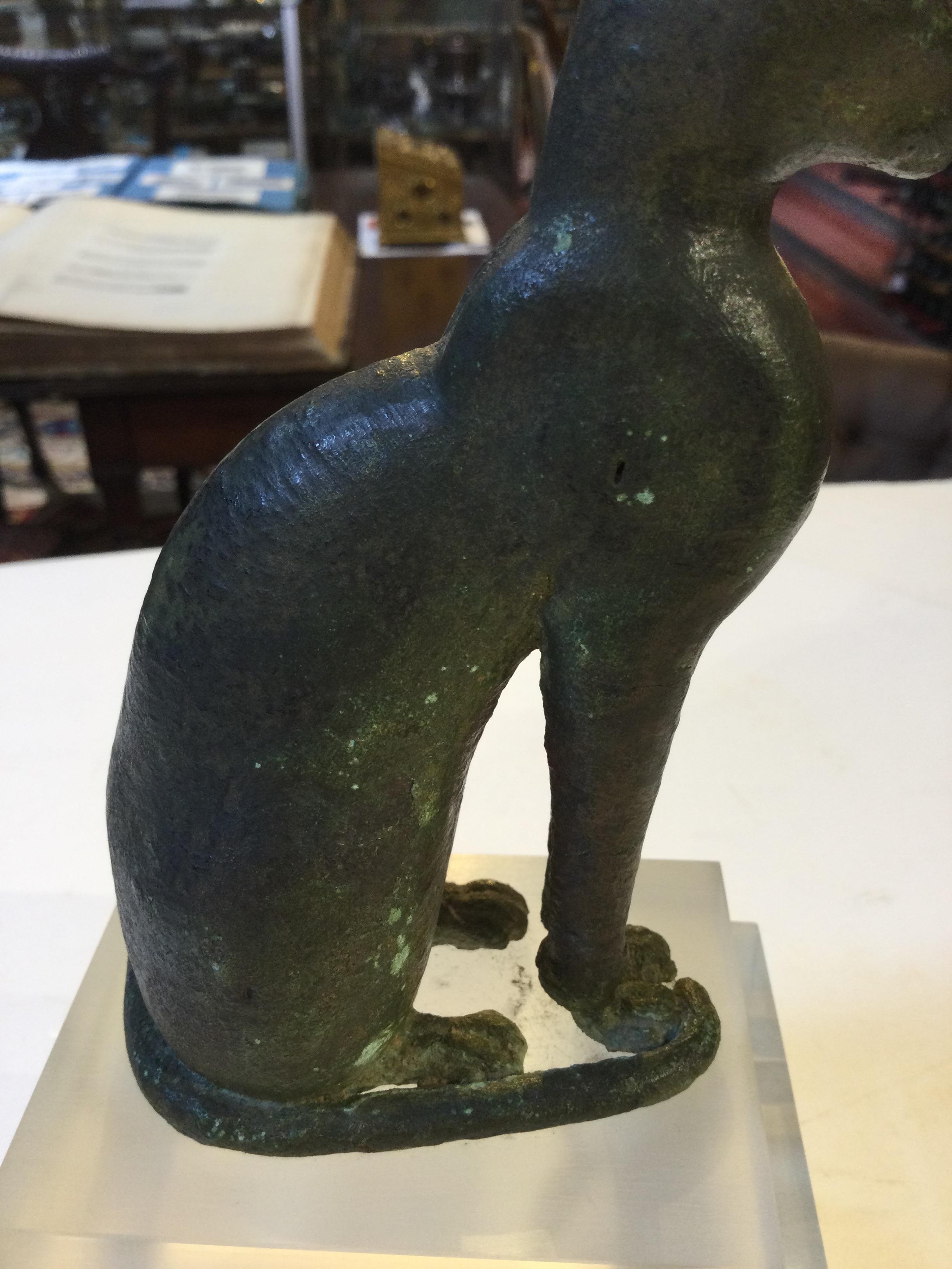 An Egyptian bronze cat figure , hollow cast, depicted seated and alert with forepaws together and - Image 21 of 26