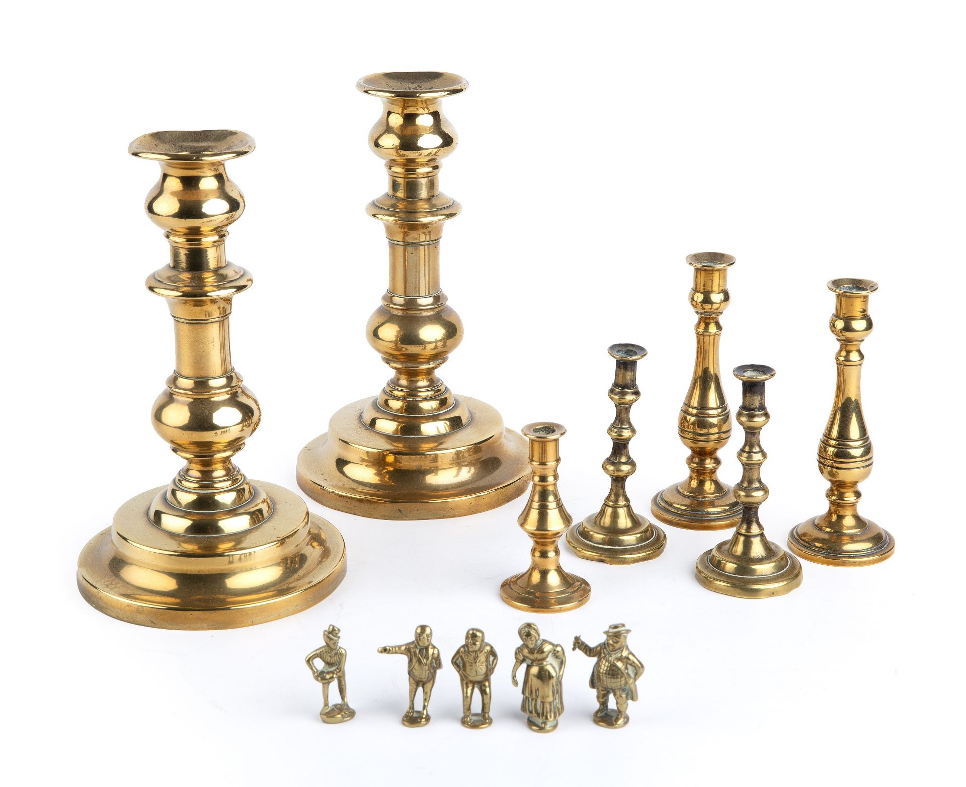 19th century brassware to include candlesticks, tapersticks and small Dickens figures