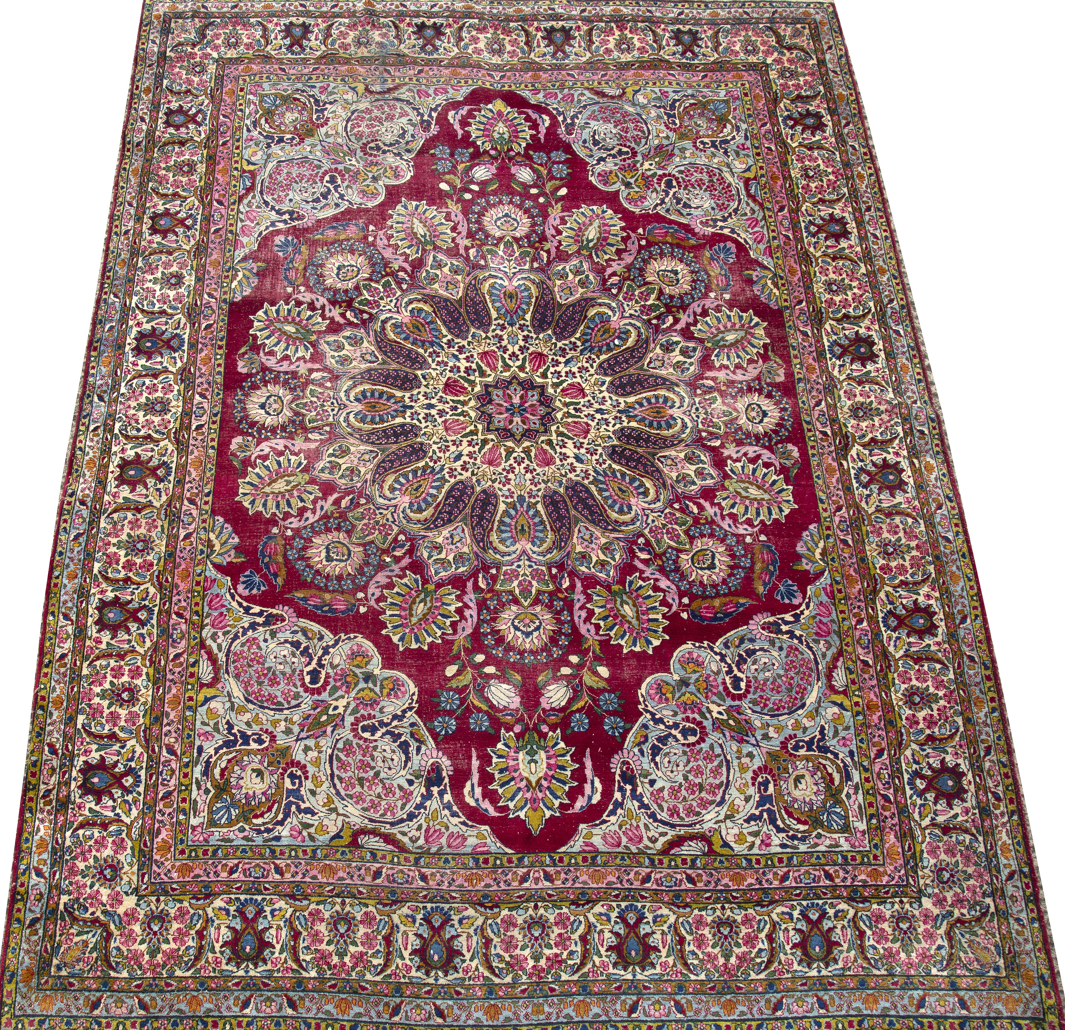 A Persian Kirman polychrome carpet with a banded border and foliate decoration 267cm x 355cm