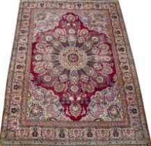 A Persian Kirman polychrome carpet with a banded border and foliate decoration 267cm x 355cm