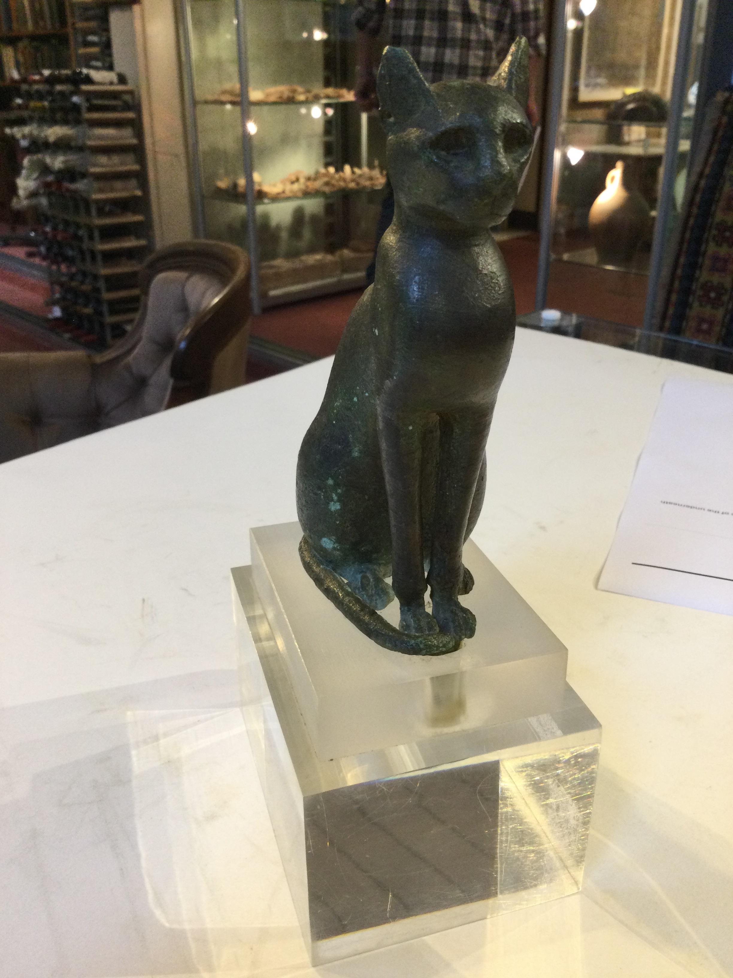 An Egyptian bronze cat figure , hollow cast, depicted seated and alert with forepaws together and - Image 8 of 26