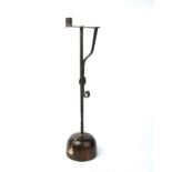 An 18th century wrought iron rush light with a turned oak base 16cm wide 54cm high.