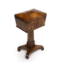 An early 19th century burr yew wood teapoy of sarcophagus form, the top opening to reveal a