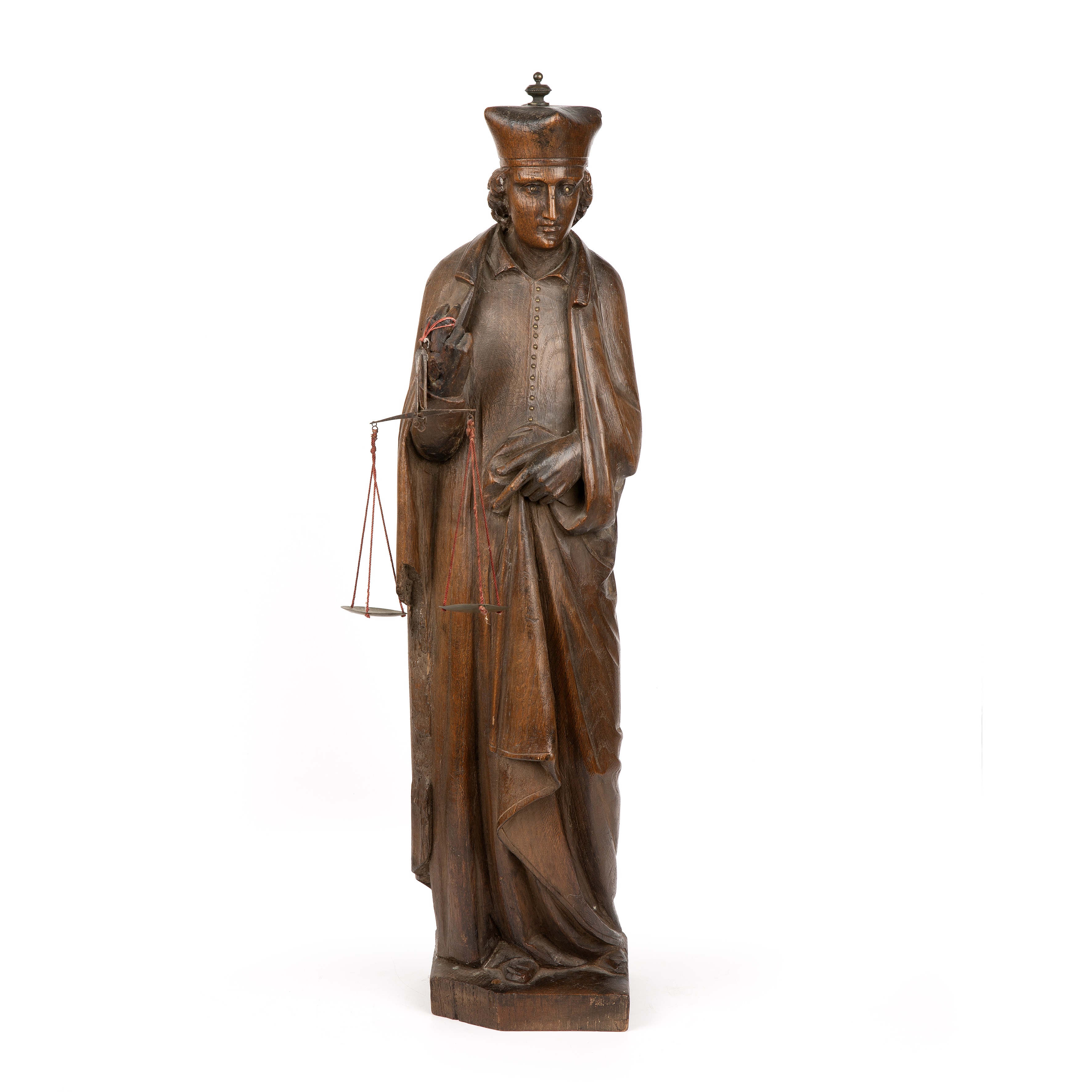 A early 19th century carved oak figure of a priest 16cm wide 65cm high. Corner missing to the