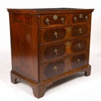 An 18th century walnut and burr wood inlaid chest of two short and three long drawers having brass