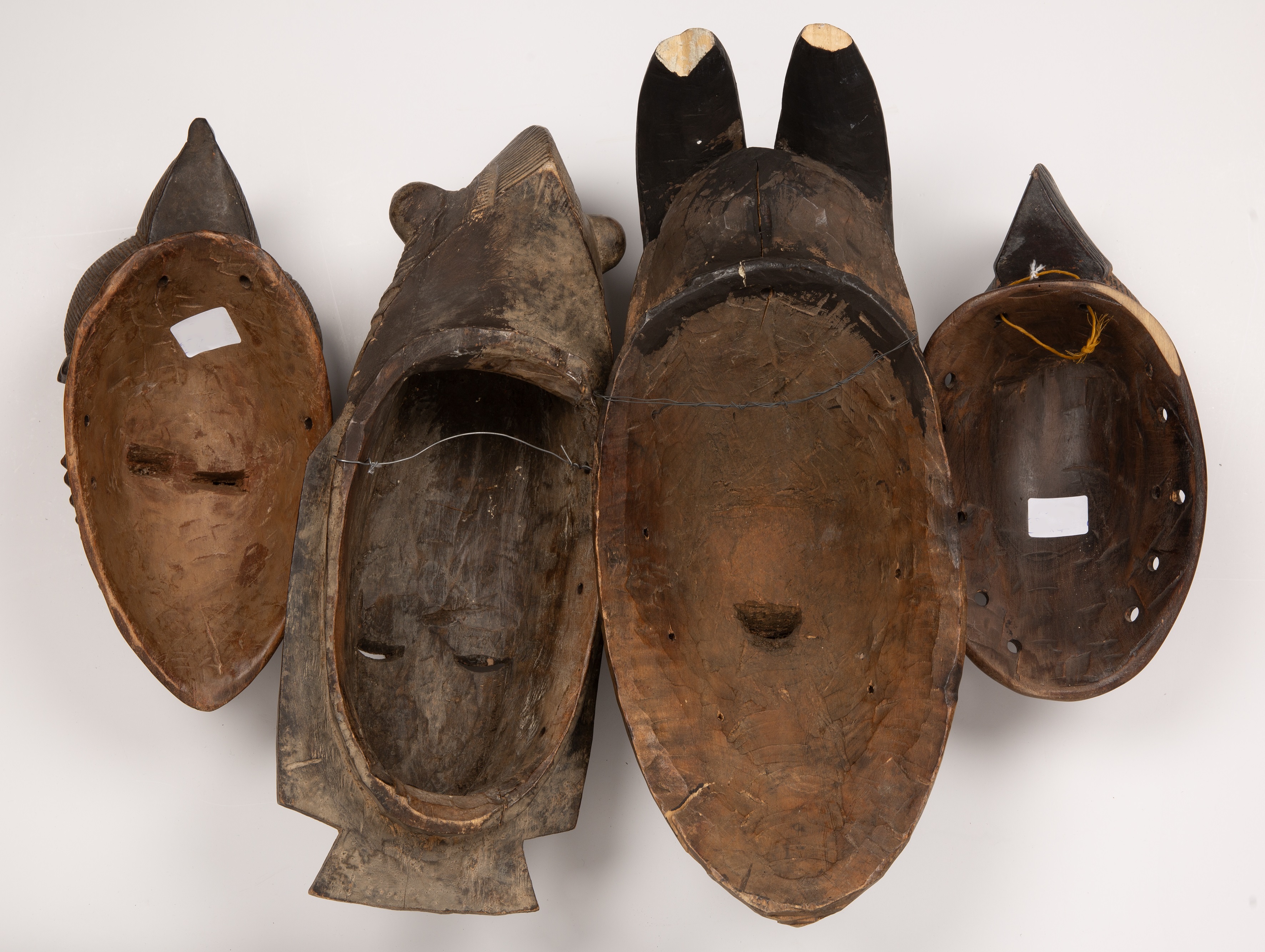 A group of four Baule masks, Ivory coast, the largest 18cm wide 45cm high. Losses to the ends of the - Image 2 of 2