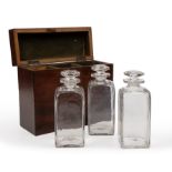 A George III mahogany decanter box, with three period glass decanters 23.5cm wide 9.5cm deep 19.
