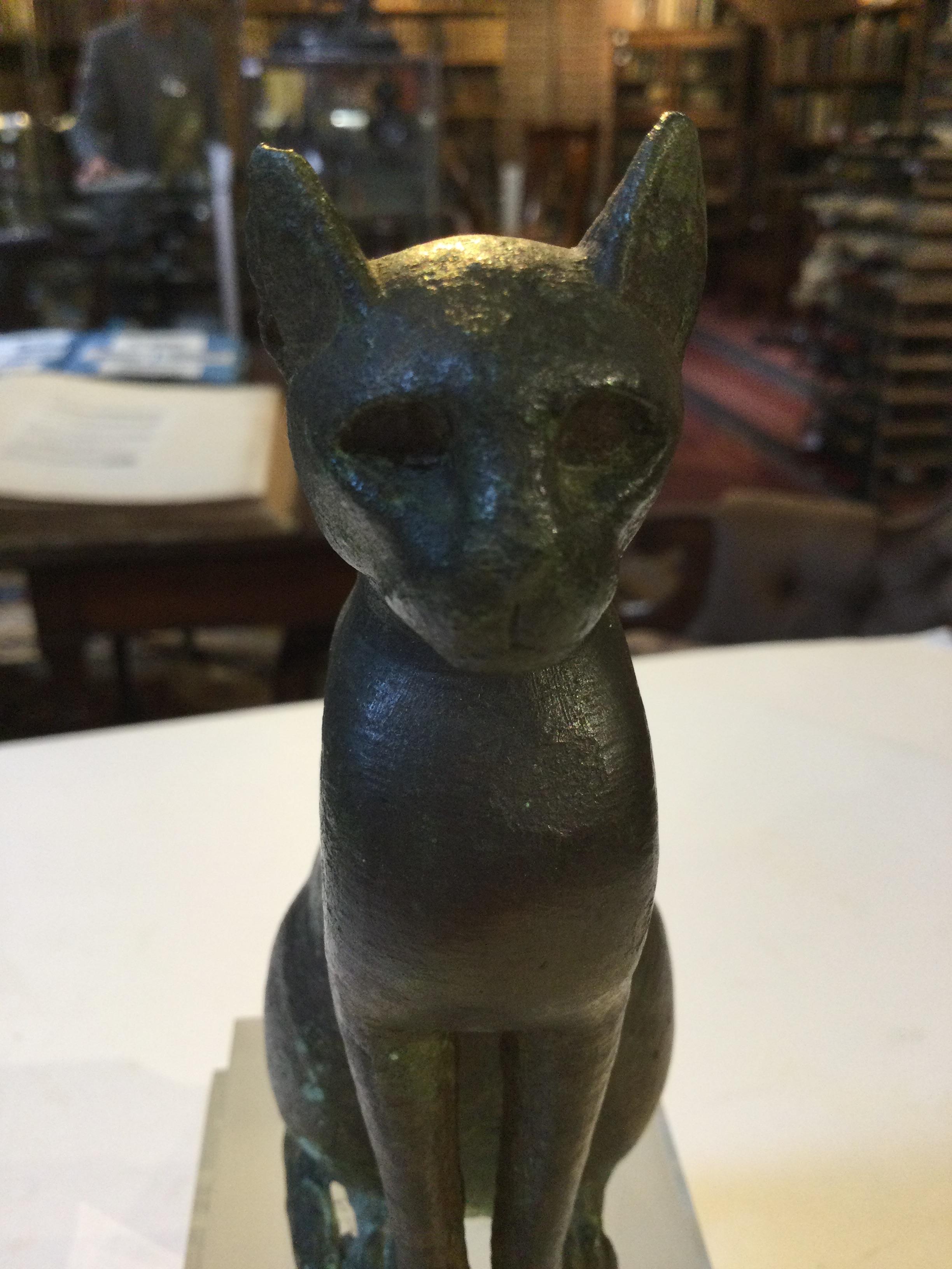 An Egyptian bronze cat figure , hollow cast, depicted seated and alert with forepaws together and - Image 22 of 26