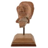 An ancient Indian terracotta head 10cm wide 16cm high
