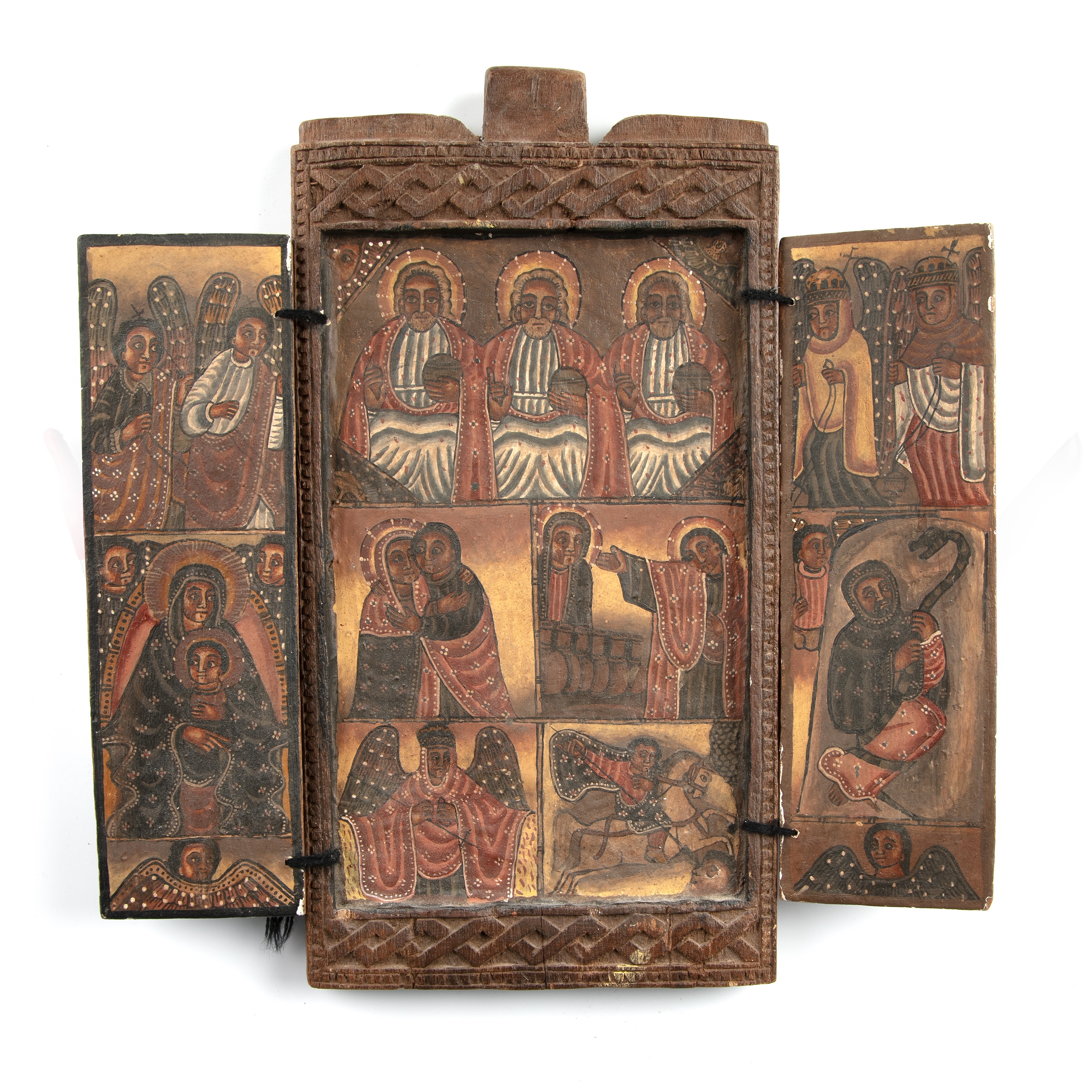 An antique Ethiopian Orthodox tryptych icon in a carved wooden frame 260 x 290mm (open) plus a