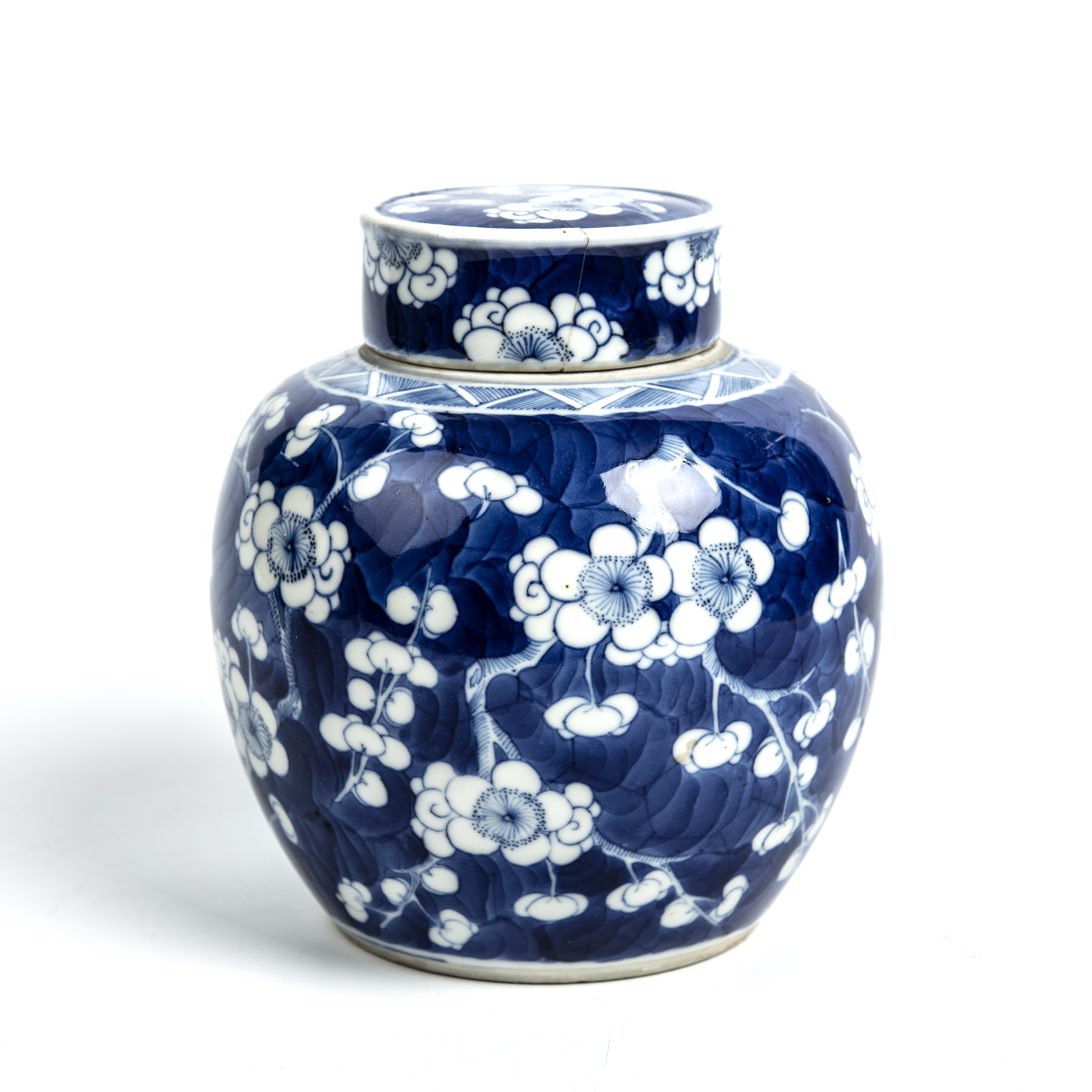 A Chinese ginger jar with blue and white prunus blossom decoration and a six character Qing mark