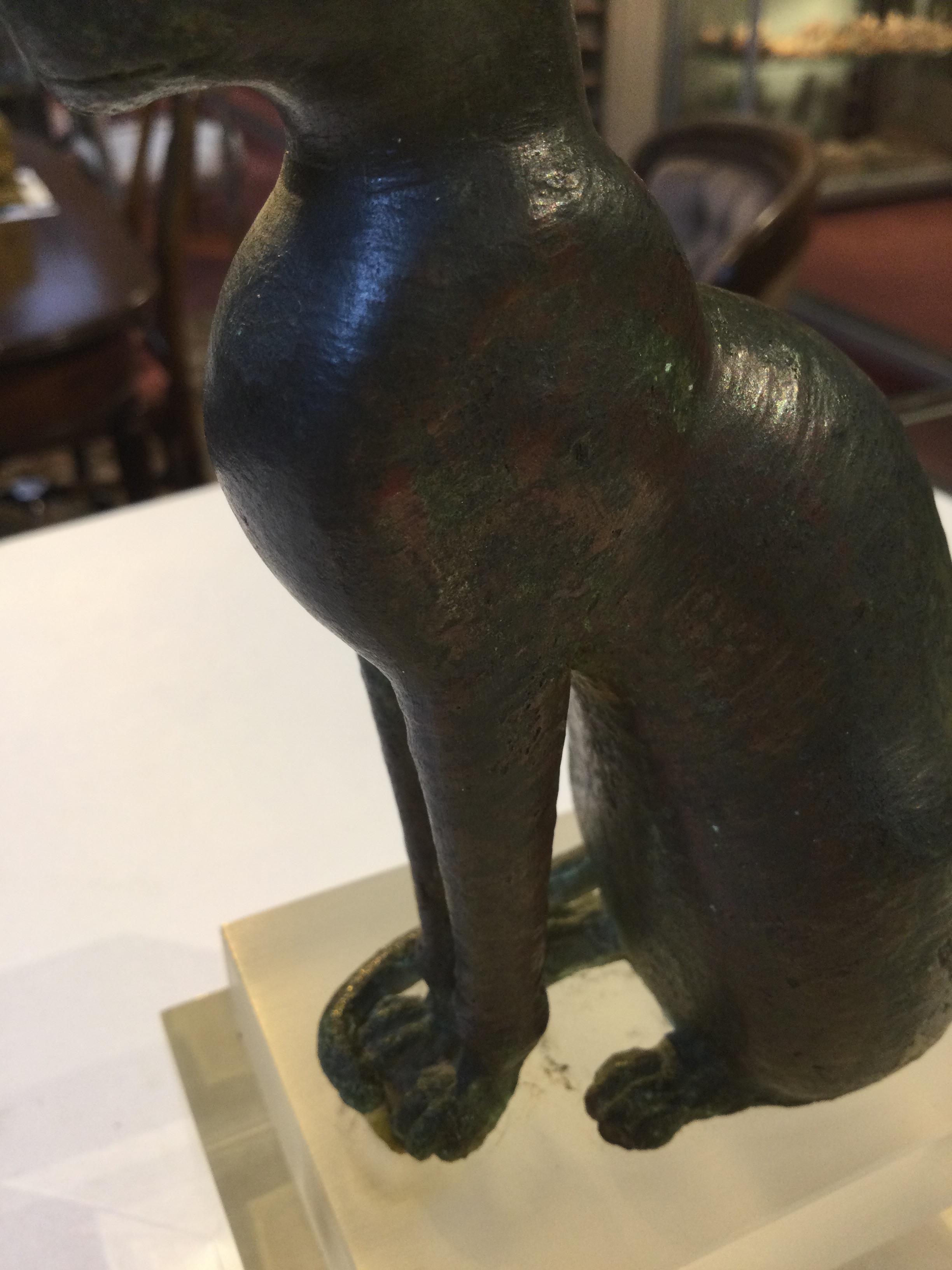An Egyptian bronze cat figure , hollow cast, depicted seated and alert with forepaws together and - Image 26 of 26