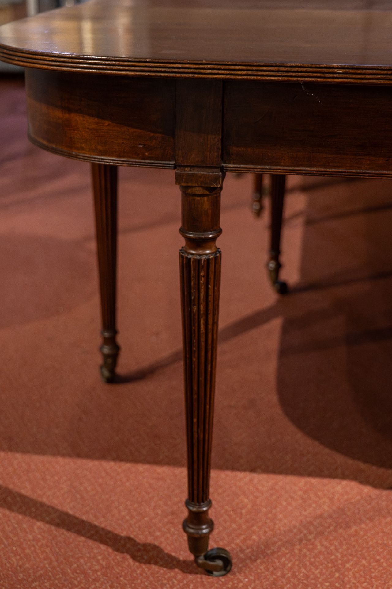 A George III and later extending dining table with reeded legs, brass castors and three leaves 312cm - Image 2 of 2
