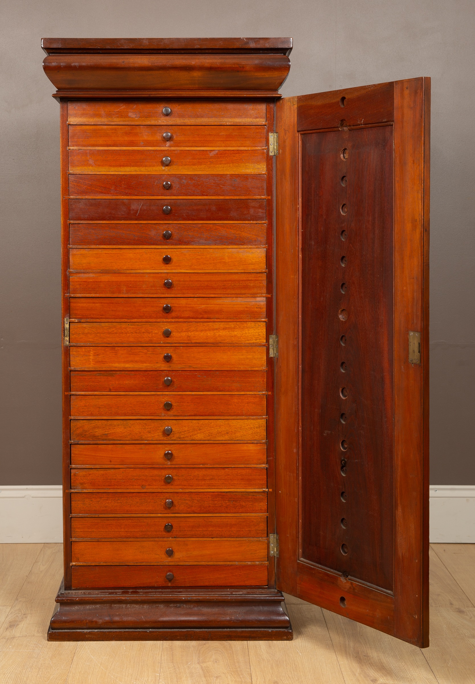 A Victorian mahogany collectors cabinet, the frieze with a blind drawer above twenty glazed-topped