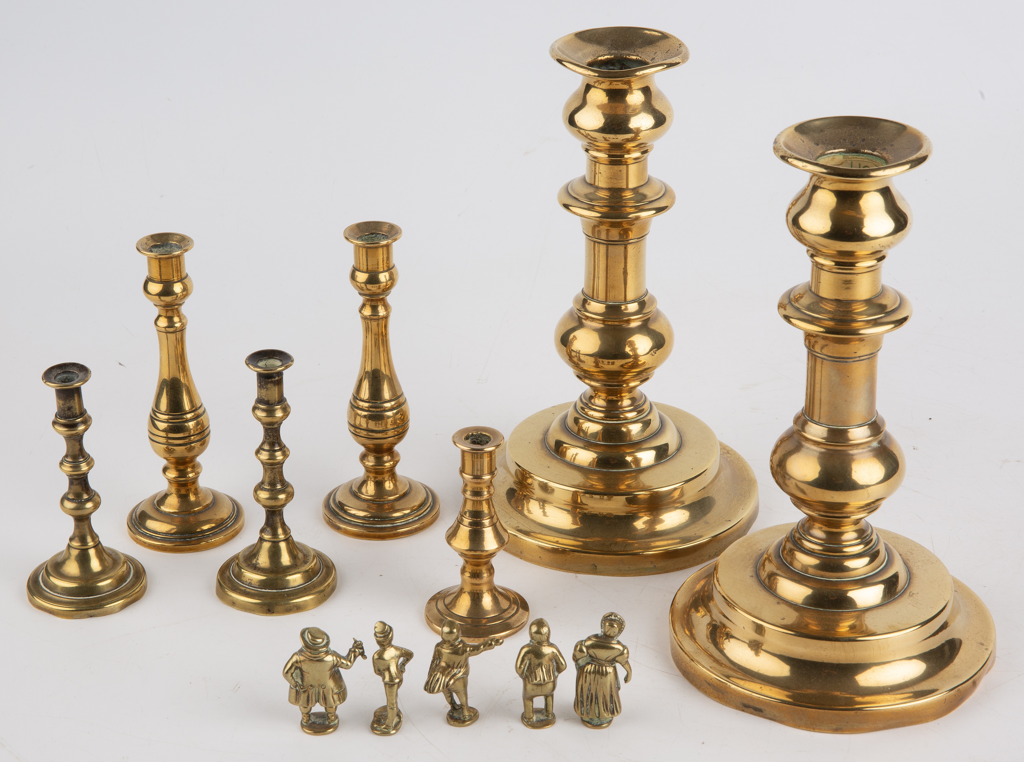 19th century brassware to include candlesticks, tapersticks and small Dickens figures - Image 2 of 4