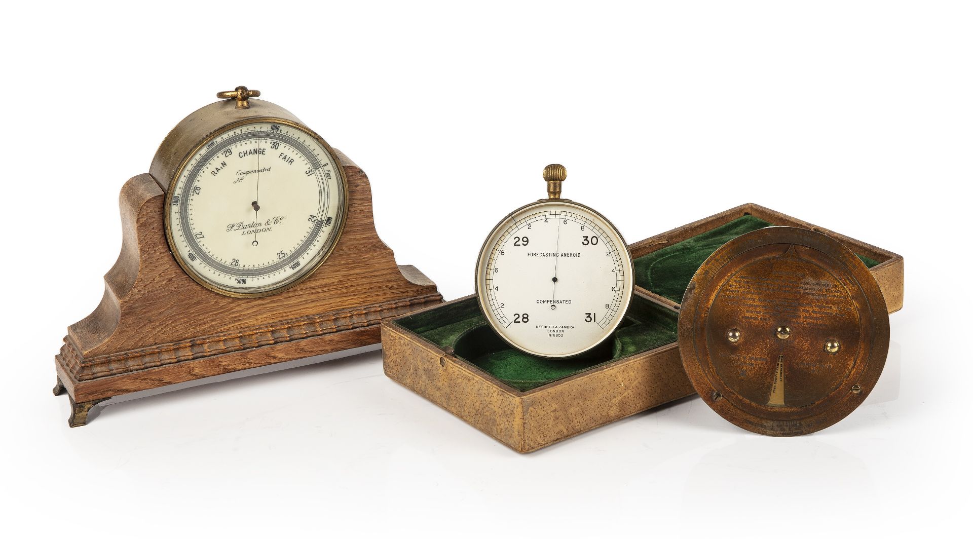 A Negretti & Zambra travellers forecasting aneroid barometer and weather forecaster, each housed