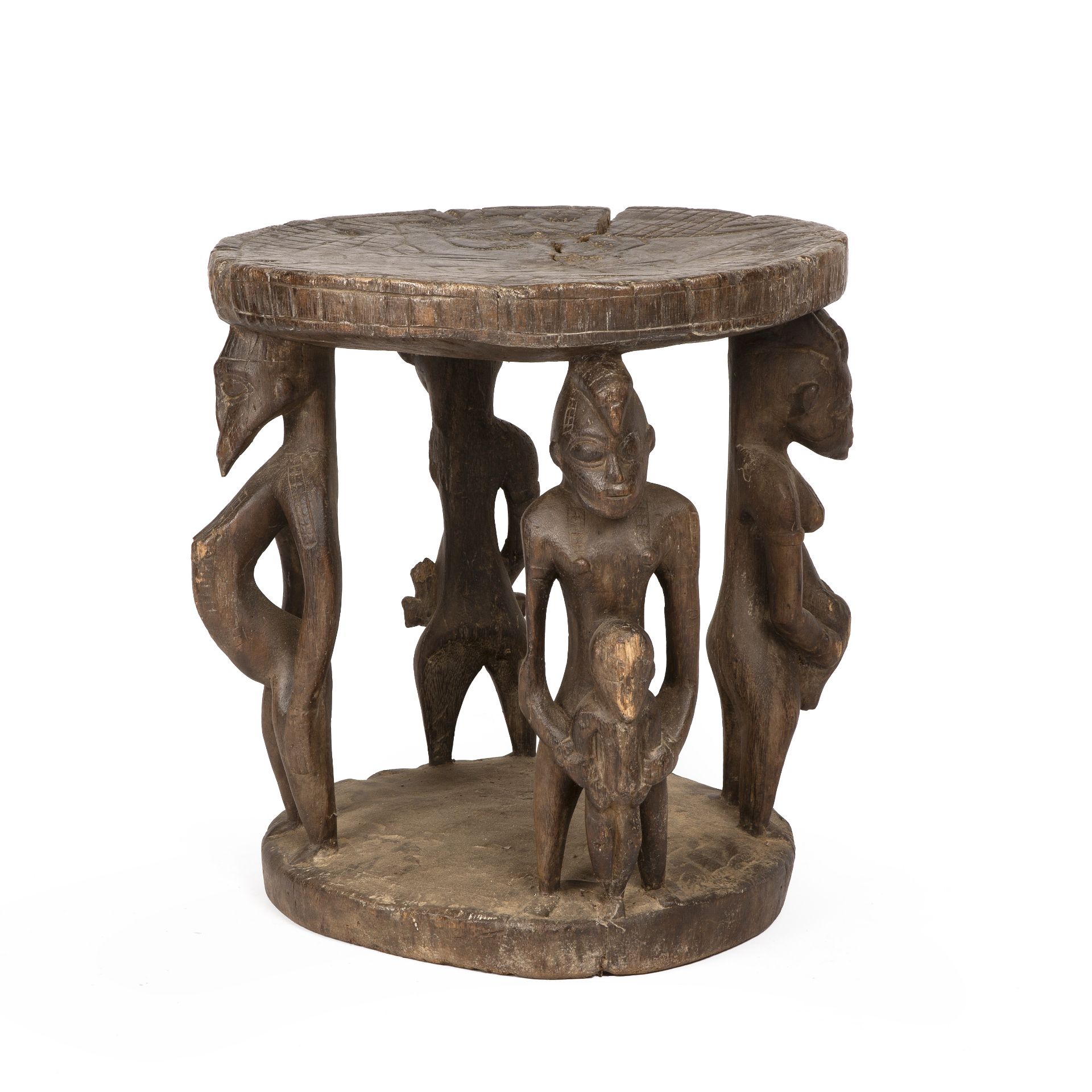 An antique Senufo stool, with four carved fertility figures, 48cm diameter 50cm high