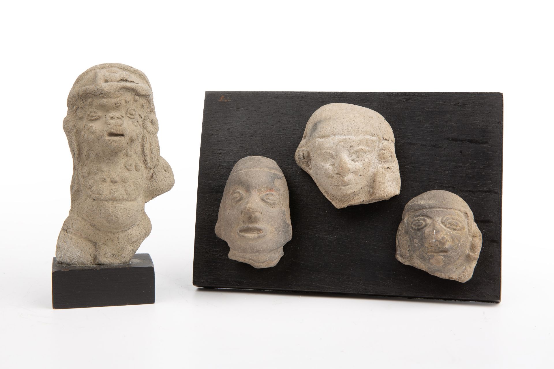 Four pre Columbian pottery heads 6cm x 5cm