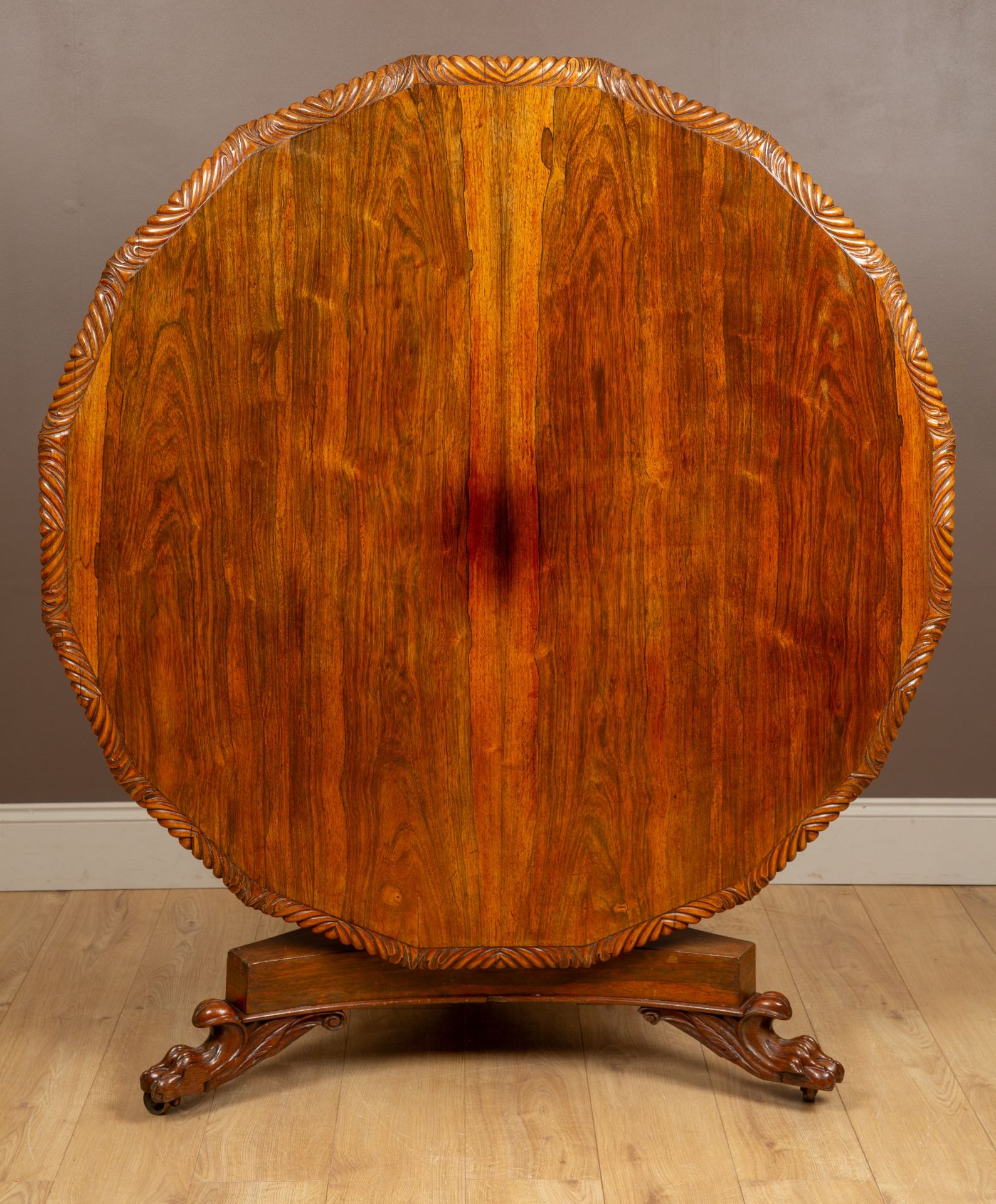 A Victorian rosewood circular centre table, with a gadrooned border, a tilt-top, a stout column