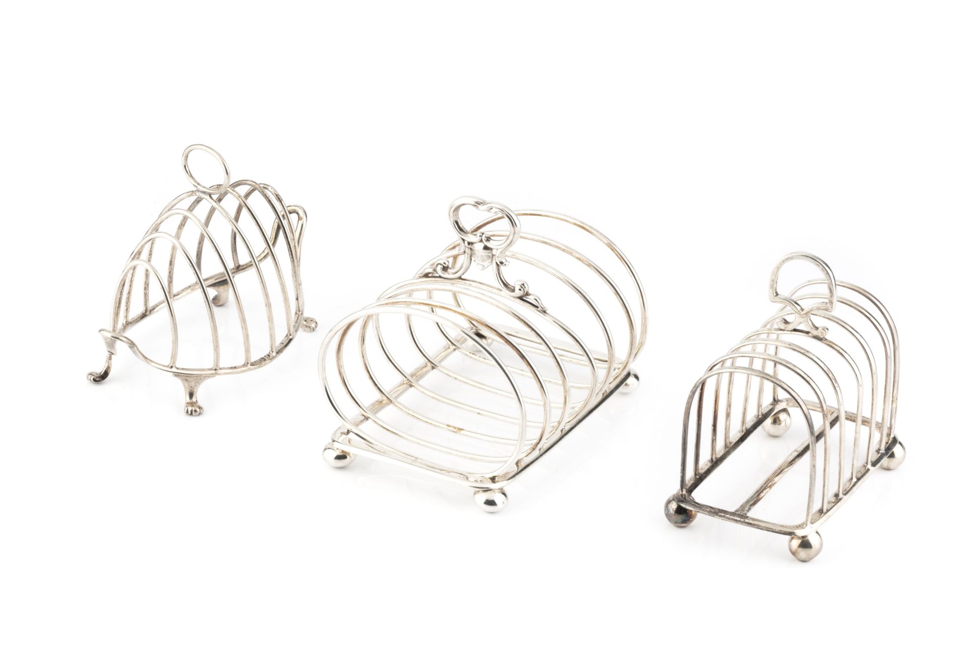 An early Victorian silver seven bar toast rack, the oval divisions with central foliate scroll