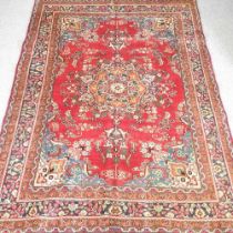 A Persian carpet, with a large central medallion, 290 x 205cm