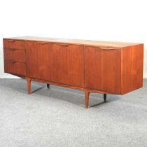 A 1970's teak sideboard, on turned legs, by McIntosh, label to inside 201w x 46d x 77h cm