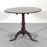 A George III oak occasional table, with a circular top, on a tripod base 80d x 68h cm