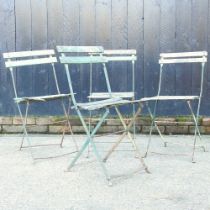 A set of four French green painted folding bistro chairs